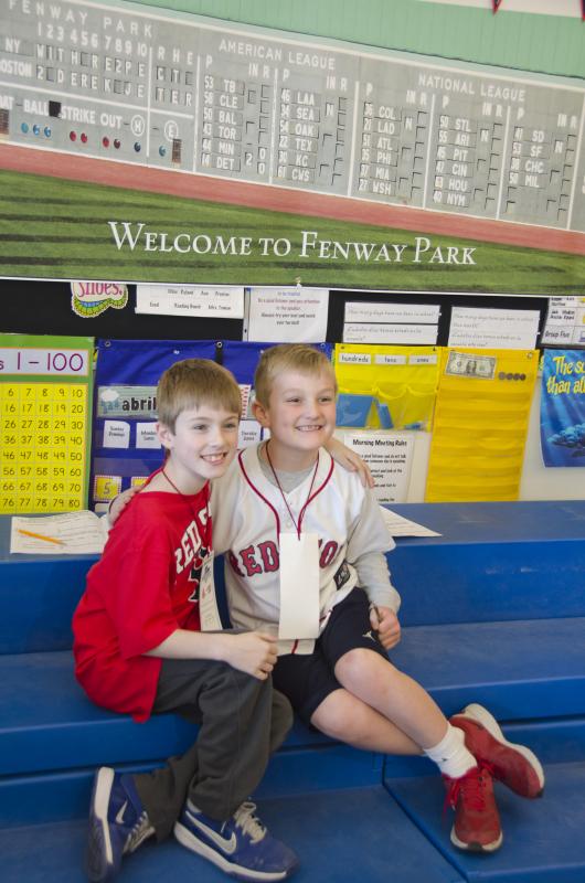 Logan Maher and Keegan Plant pose in front of Tomon's photo of Fenway Park, taken at Derek Jeter's final game in the stadium. BY GEORGIA SPARLING